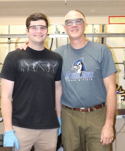 Etown professor and student posing for a photo in Musser lab.