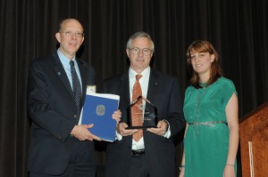 Dennis Felty with President Strikwerda and Liz Romaine, holding award