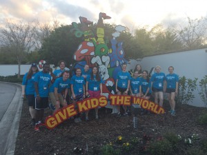 Elizabethtown College students pose in front of the "Give Kids the World" sign.